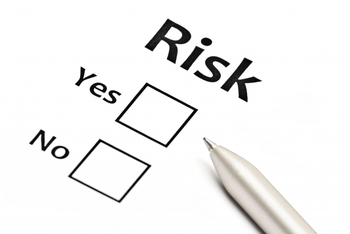 The image depicts a checklist with the word "Risk" at the top, followed by two options: "Yes" and "No," each with an empty checkbox next to it. A pen is positioned on the right side, suggesting the decision to evaluate or acknowledge risk is yet to be made.